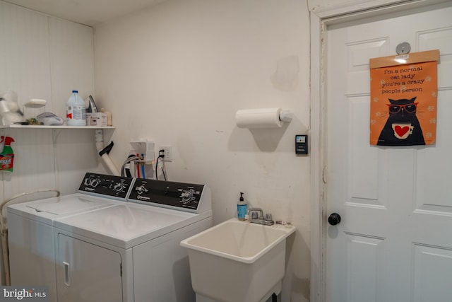 washroom featuring separate washer and dryer and sink