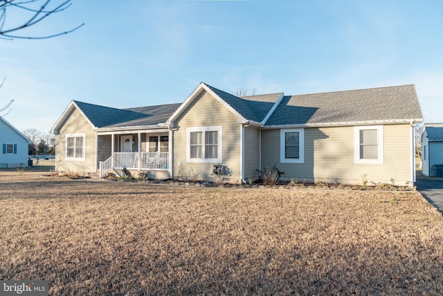 ranch-style home with a porch and a front lawn