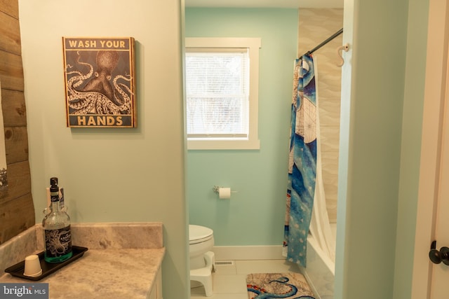 full bathroom with tile patterned floors, shower / tub combo with curtain, vanity, and toilet