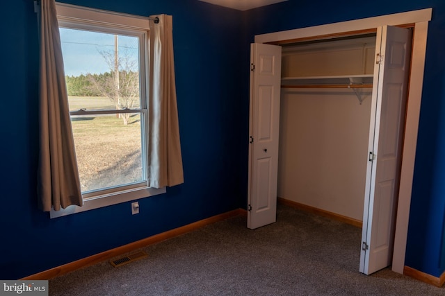 unfurnished bedroom with carpet flooring and a closet