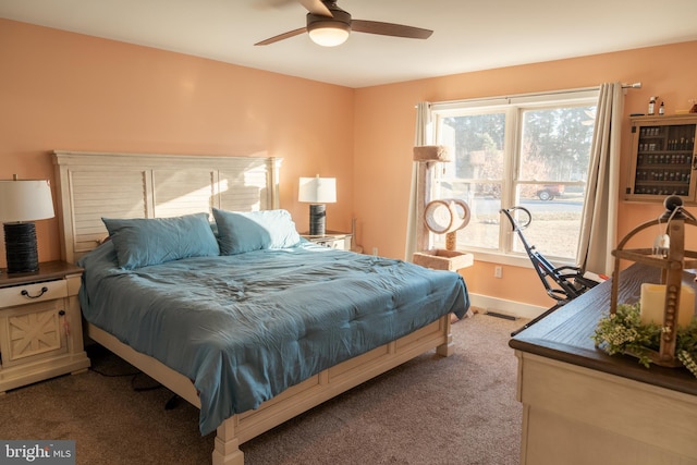 carpeted bedroom featuring ceiling fan and multiple windows