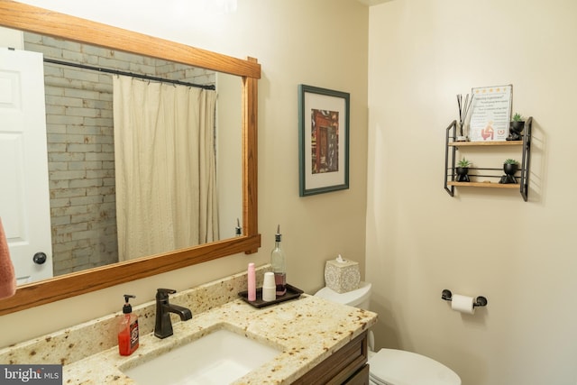 bathroom with vanity, toilet, and walk in shower