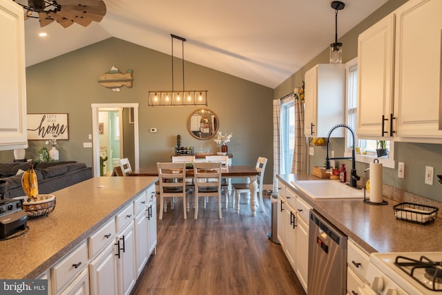 kitchen with dishwasher, white cabinetry, sink, and hanging light fixtures