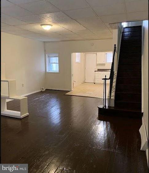 unfurnished living room with dark hardwood / wood-style floors