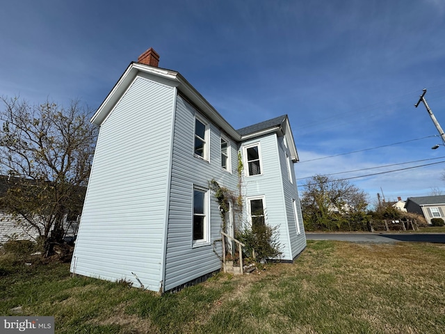 view of property exterior featuring a lawn