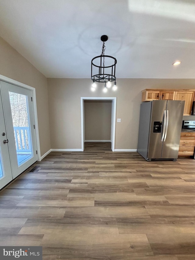 unfurnished dining area with light hardwood / wood-style flooring