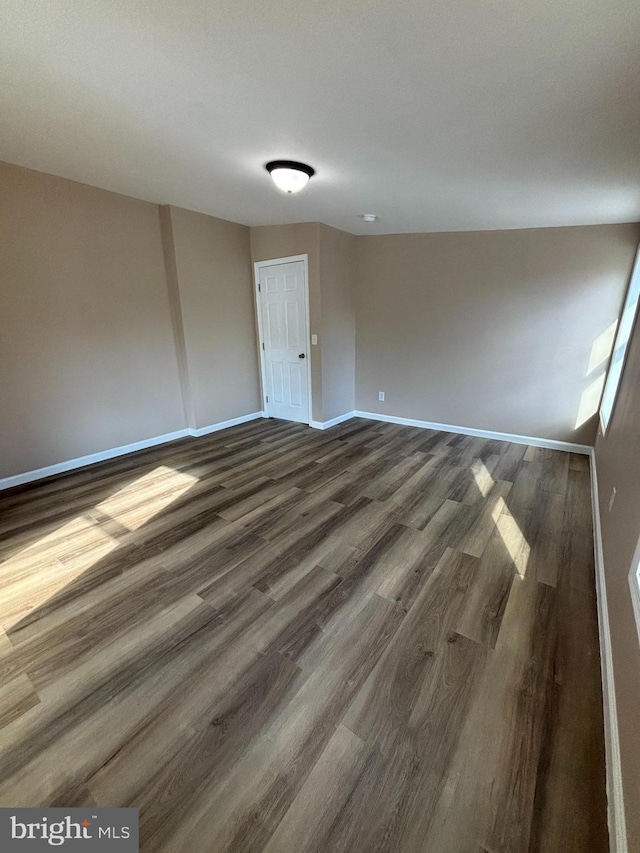 unfurnished room featuring dark hardwood / wood-style flooring