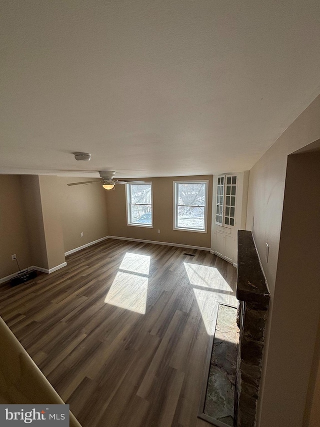 interior space with dark hardwood / wood-style floors and ceiling fan