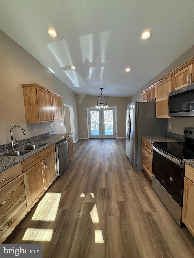 kitchen with pendant lighting, sink, stainless steel appliances, dark wood-type flooring, and french doors