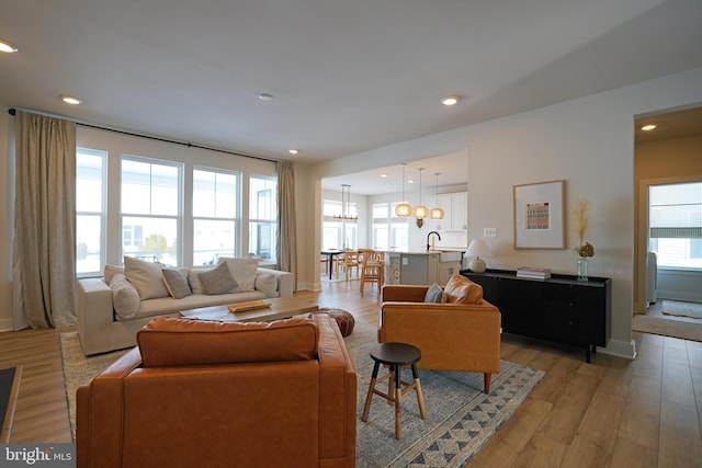 living room featuring light wood-type flooring and sink