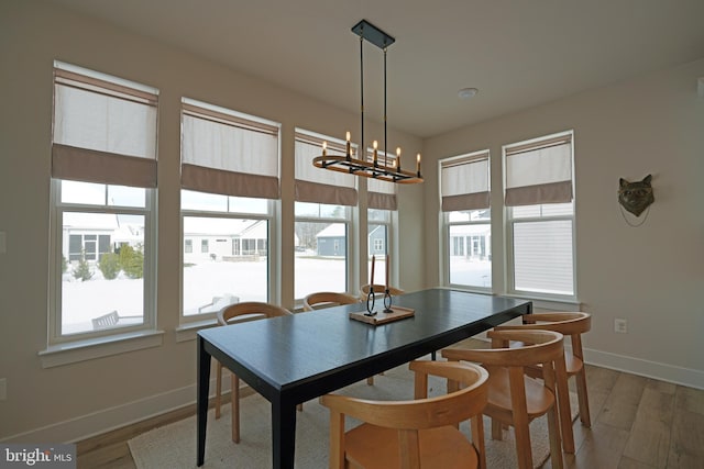 dining space with a chandelier and hardwood / wood-style flooring