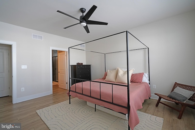 bedroom with light wood-type flooring and ceiling fan