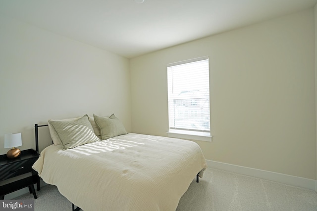 carpeted bedroom featuring multiple windows