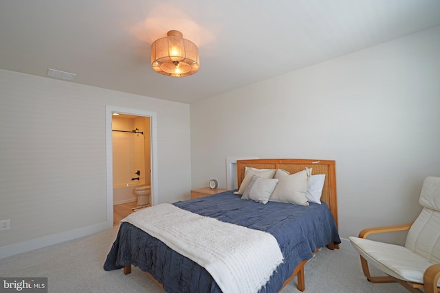 carpeted bedroom featuring ensuite bathroom