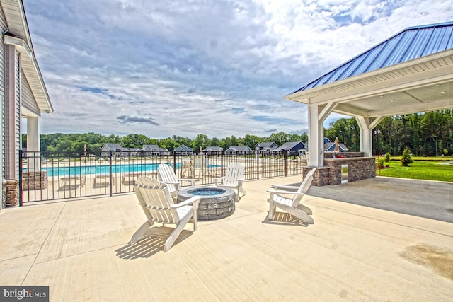 view of patio featuring a fire pit and a fenced in pool