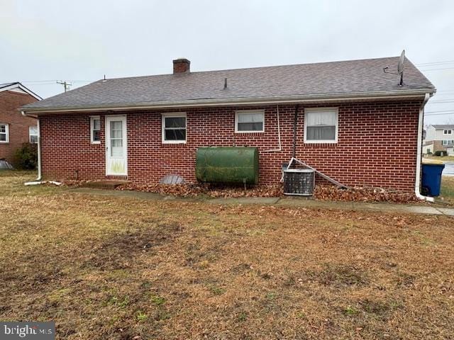 rear view of house with a yard