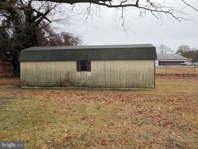 view of outdoor structure with a lawn