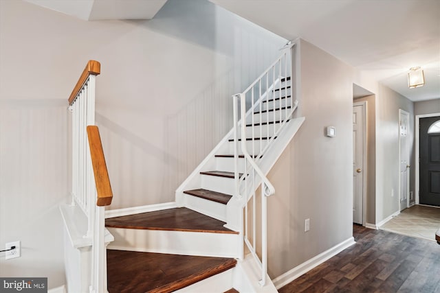 staircase with hardwood / wood-style floors