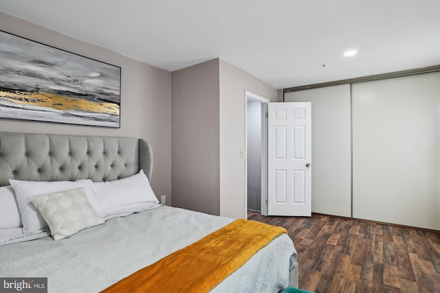 bedroom with a closet and dark wood-type flooring