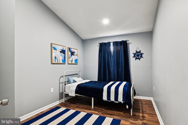 bedroom featuring dark hardwood / wood-style floors and vaulted ceiling