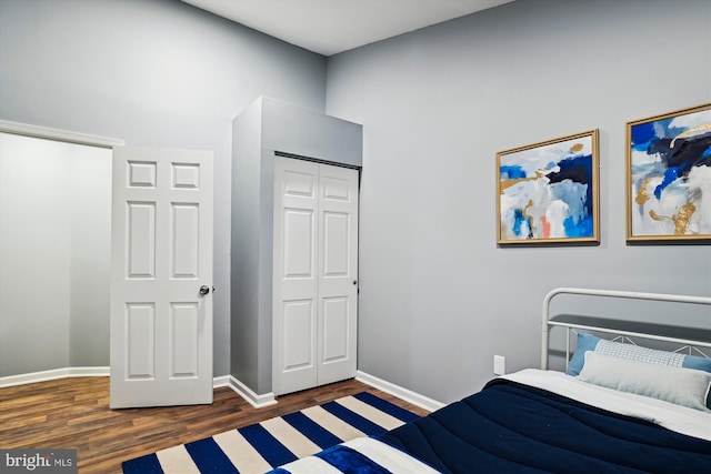 bedroom featuring a closet and dark wood-type flooring