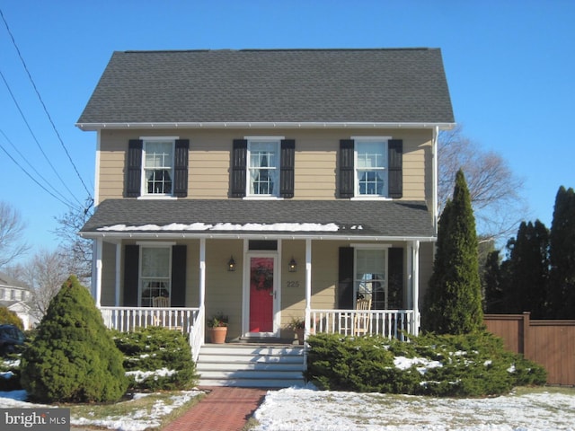 colonial-style house featuring covered porch