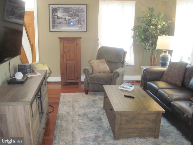 living room featuring dark hardwood / wood-style floors and a baseboard radiator