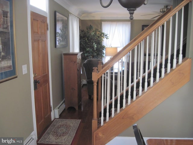 foyer featuring ceiling fan, crown molding, and a baseboard radiator