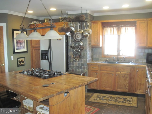 kitchen with sink, stainless steel refrigerator with ice dispenser, decorative backsplash, gas stovetop, and butcher block counters