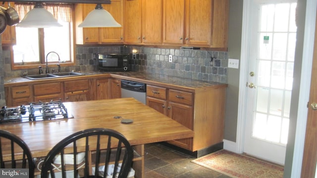 kitchen featuring appliances with stainless steel finishes, backsplash, and sink