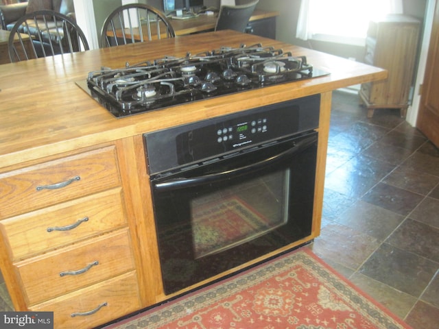 details featuring radiator heating unit and black appliances