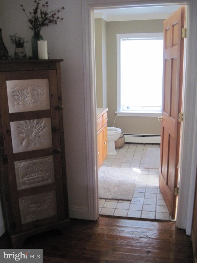 hallway featuring light hardwood / wood-style floors and a baseboard heating unit