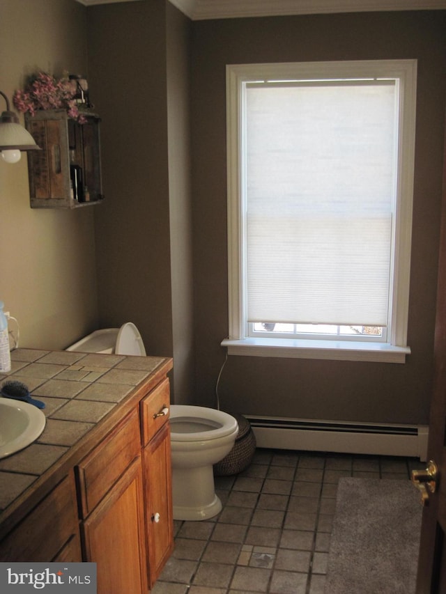 bathroom with vanity, toilet, and a baseboard radiator