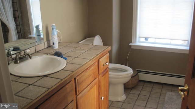 bathroom featuring tile patterned flooring, vanity, toilet, and a baseboard radiator