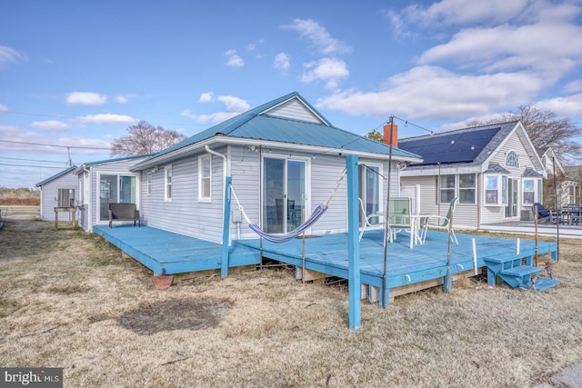 rear view of house featuring a wooden deck