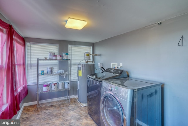 laundry room with electric water heater and independent washer and dryer