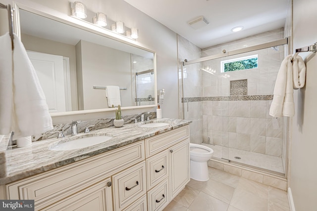 bathroom featuring tile patterned flooring, vanity, toilet, and a shower with shower door