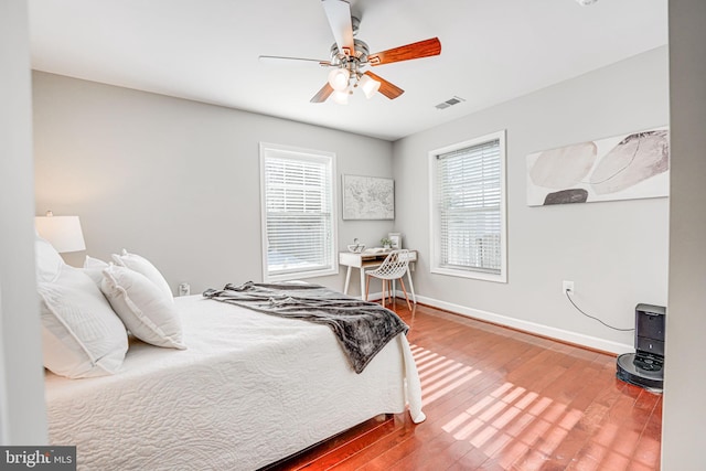 bedroom with hardwood / wood-style floors and ceiling fan