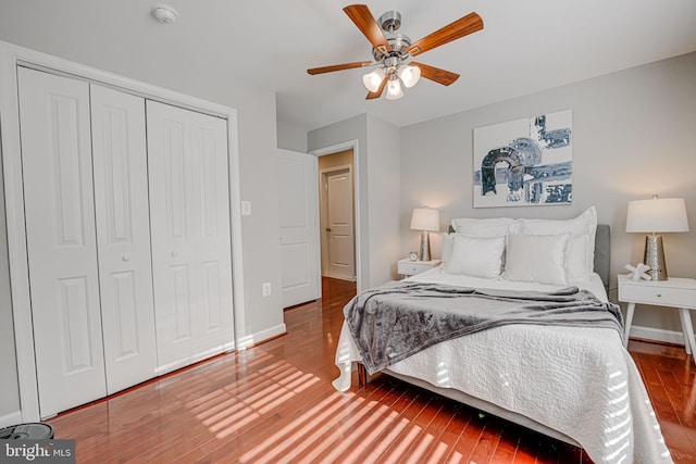 bedroom with ceiling fan, a closet, and hardwood / wood-style flooring