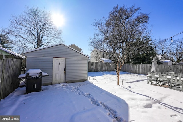 yard covered in snow with an outdoor structure