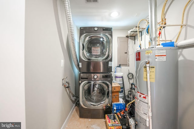 washroom with gas water heater and stacked washer / drying machine