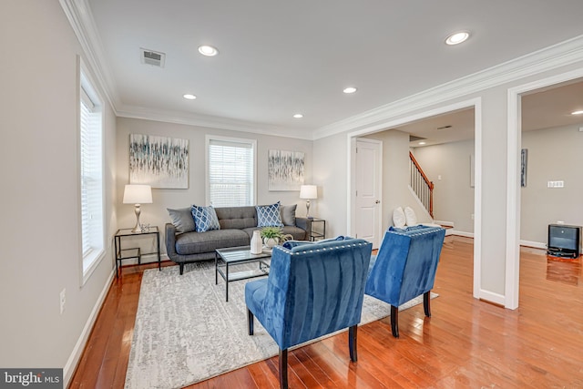 living room featuring hardwood / wood-style floors and ornamental molding