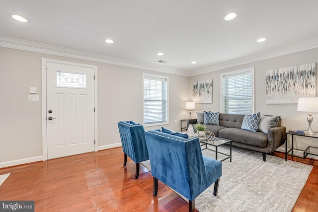 living room featuring wood-type flooring and crown molding