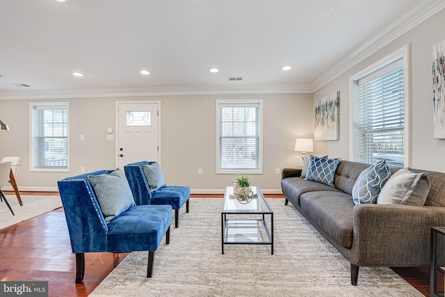 living room with a healthy amount of sunlight, wood-type flooring, and ornamental molding