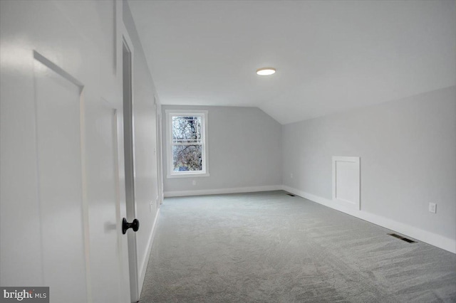 bonus room featuring carpet and vaulted ceiling