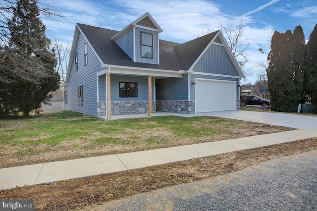 view of front of house with a front yard and a garage