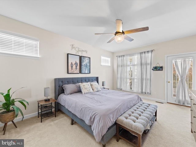 carpeted bedroom featuring ceiling fan and access to exterior