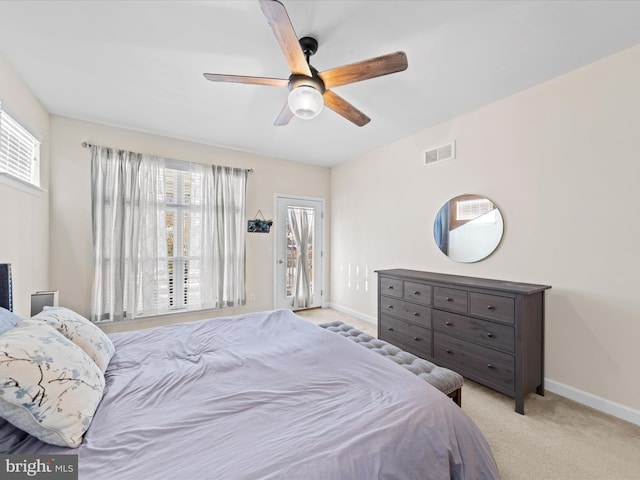 bedroom with ceiling fan and light carpet