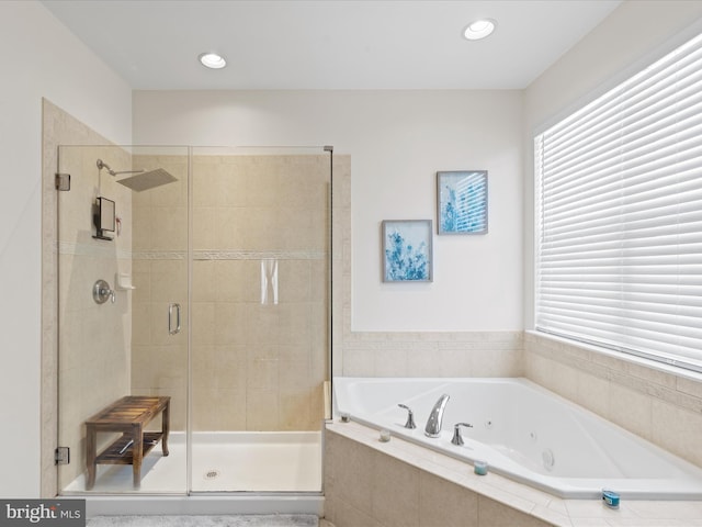 bathroom with separate shower and tub