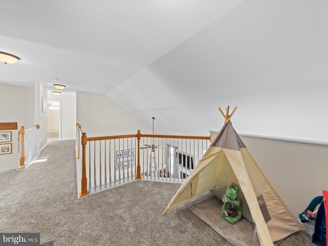 playroom featuring carpet floors and vaulted ceiling